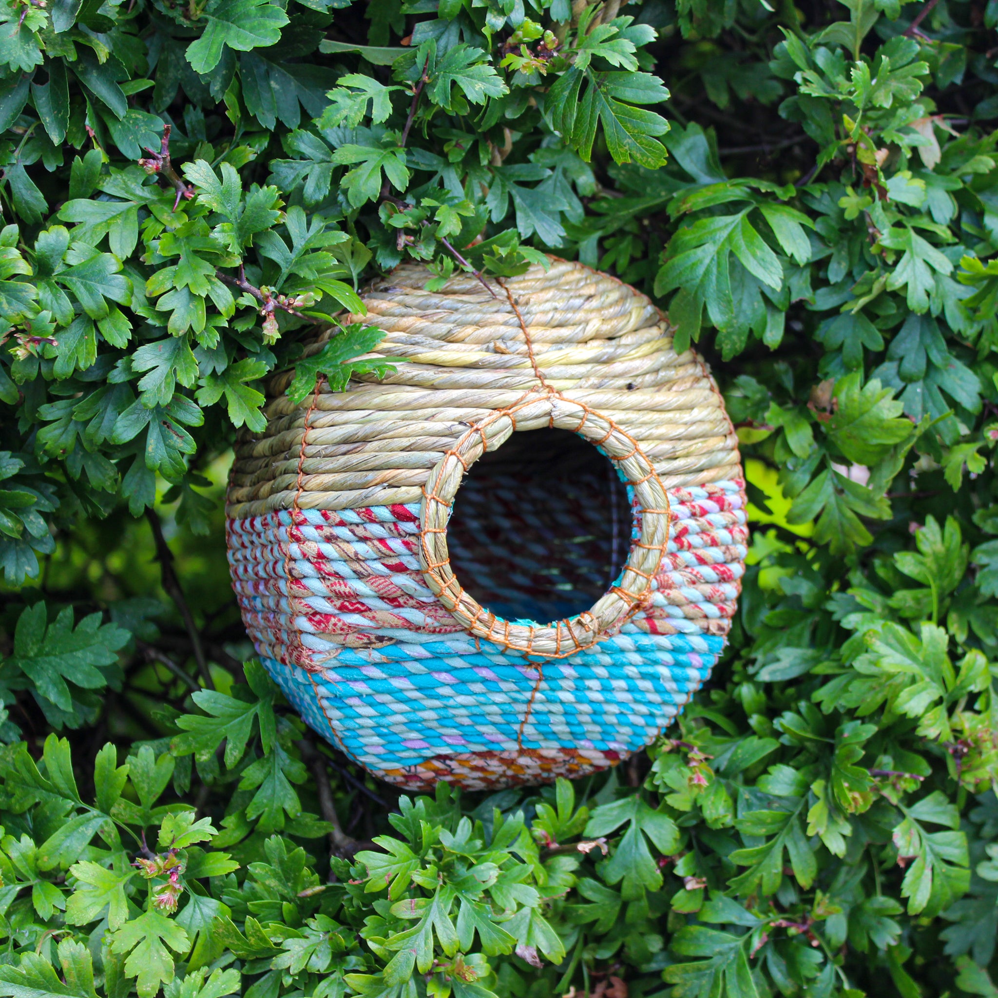 Fair trade, large, rounded artisan bird nester made from recycled saris and natural hogla grass.