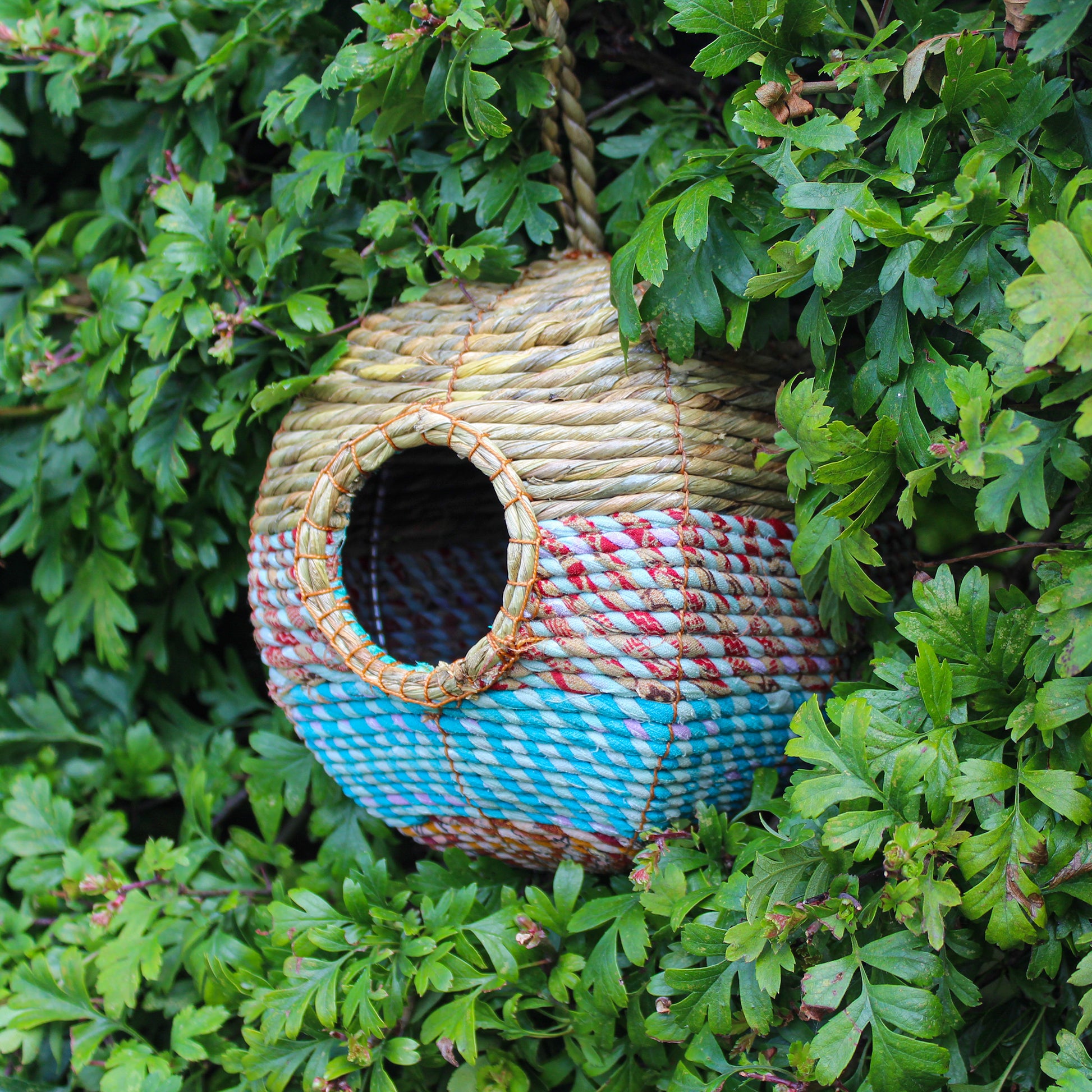 Fair trade, large, rounded artisan bird nester made from recycled saris and natural hogla grass.