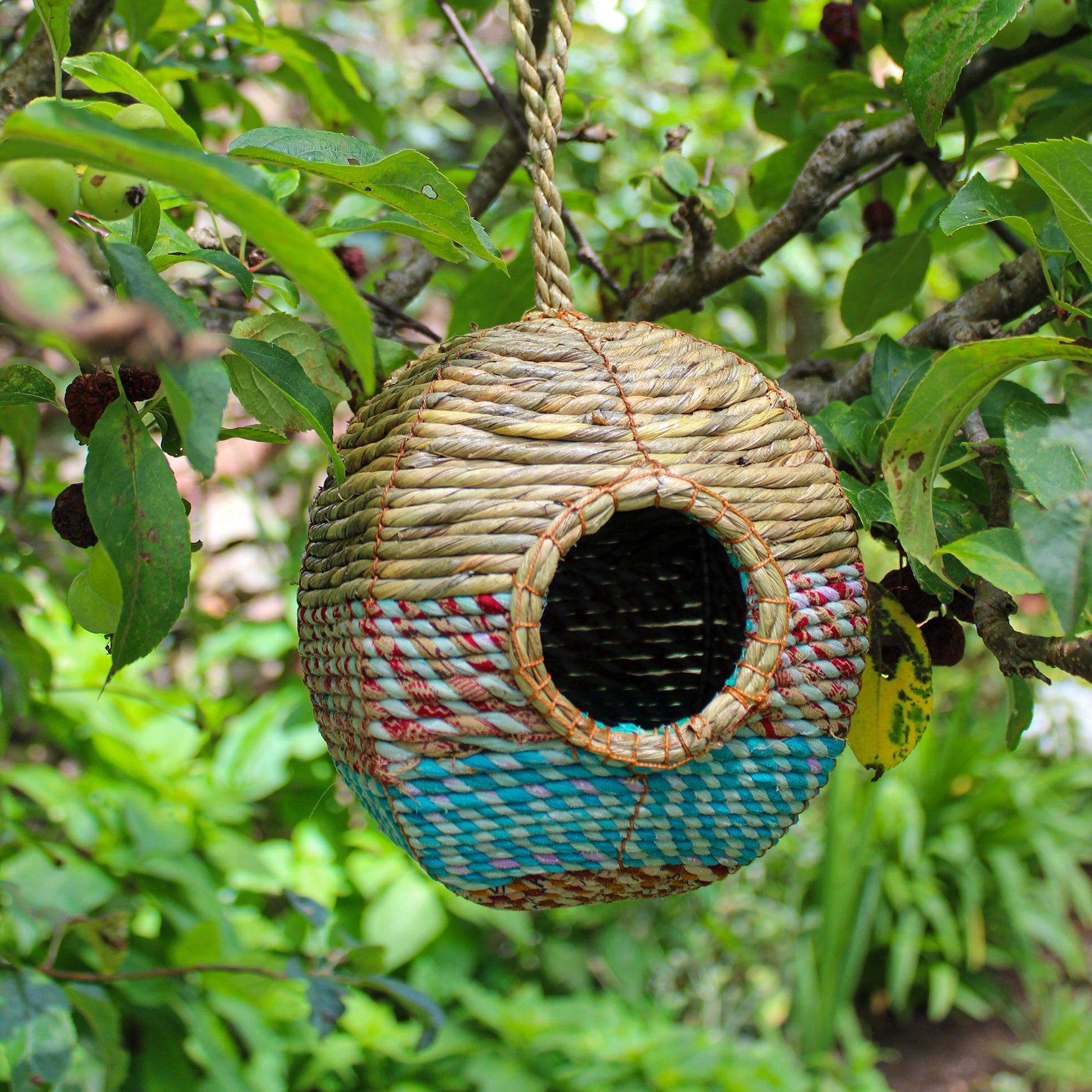 Fair trade, large, rounded artisan bird nester made from recycled saris and natural hogla grass.