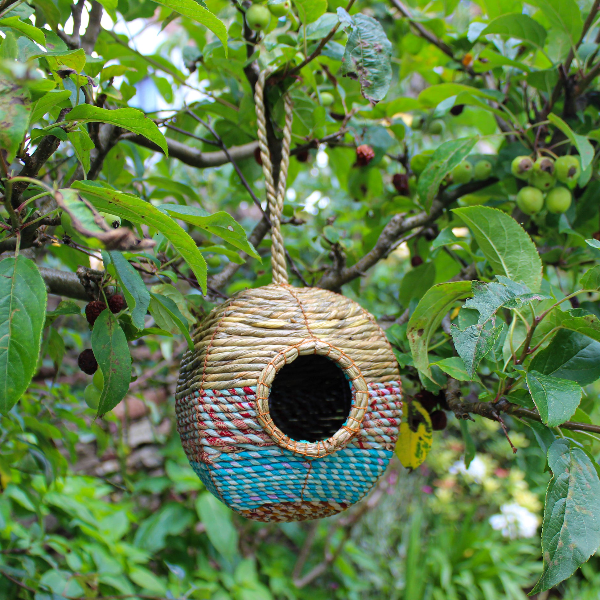 Fair trade, large, rounded artisan bird nester made from recycled saris and natural hogla grass.