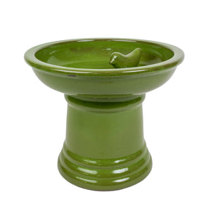 Ceramic pedestal bird bath in green.
