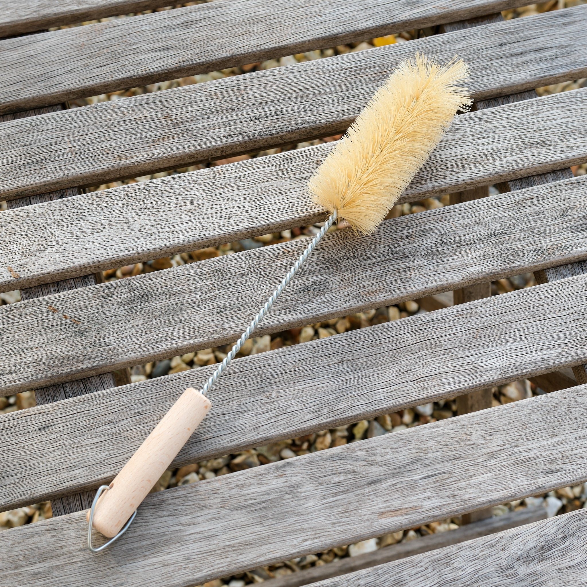 Plastic free bird feeder cleaning brush made of wood and natural bristles.