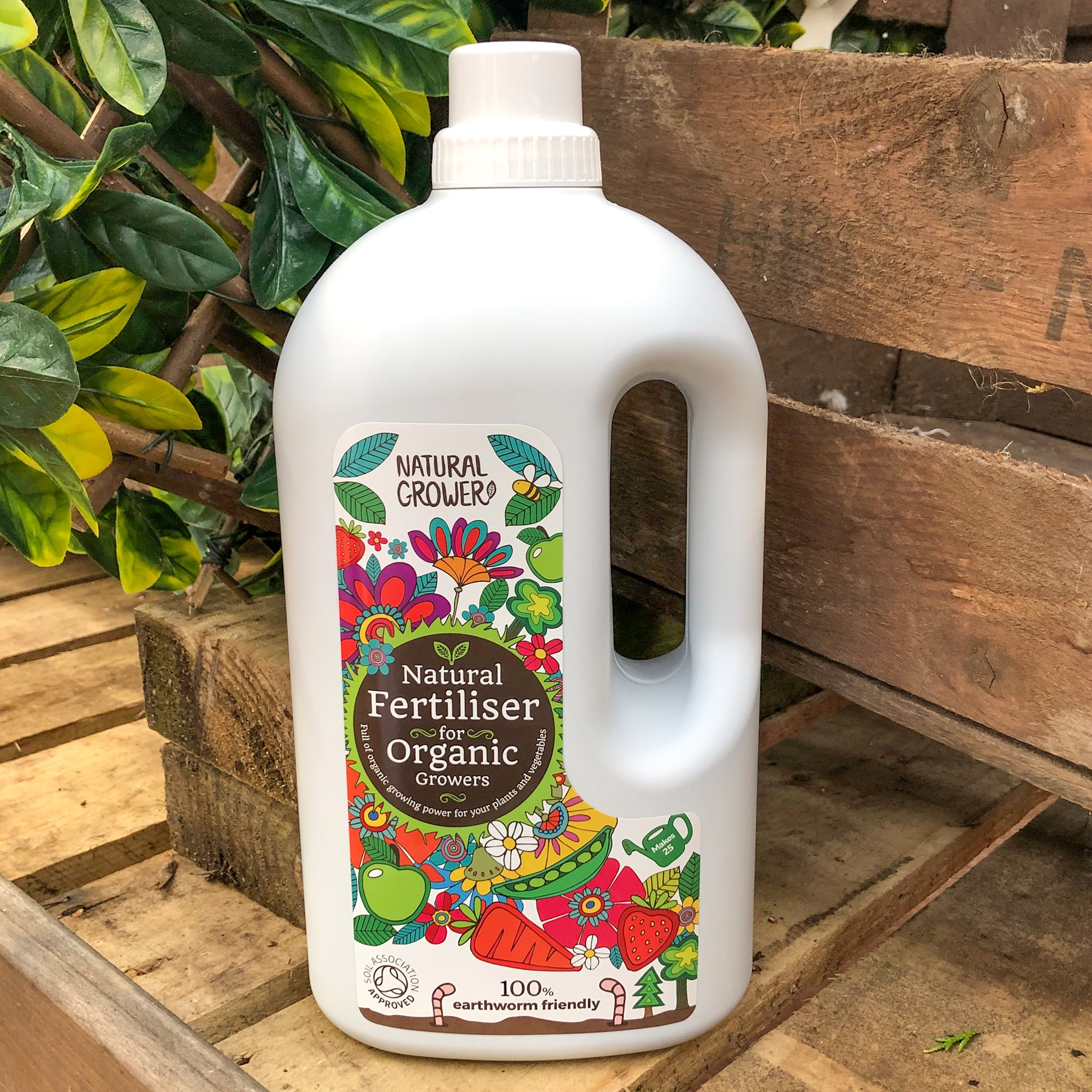 2 litre bottle of natural grower organic fertiliser on a wooden surface outside.