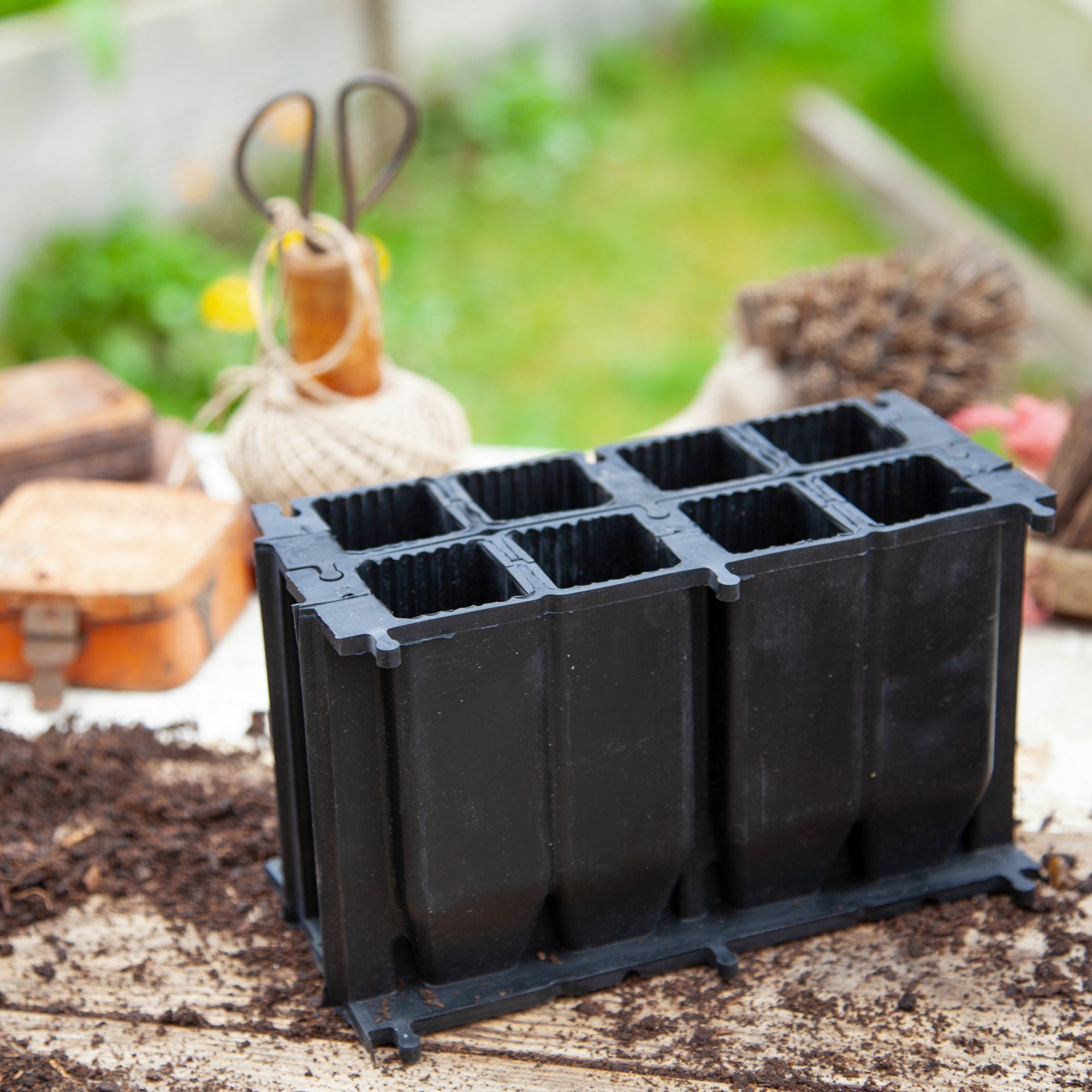 Black, plastic free, eight cell root trainer made of FSC certified, fair trade natural rubber.