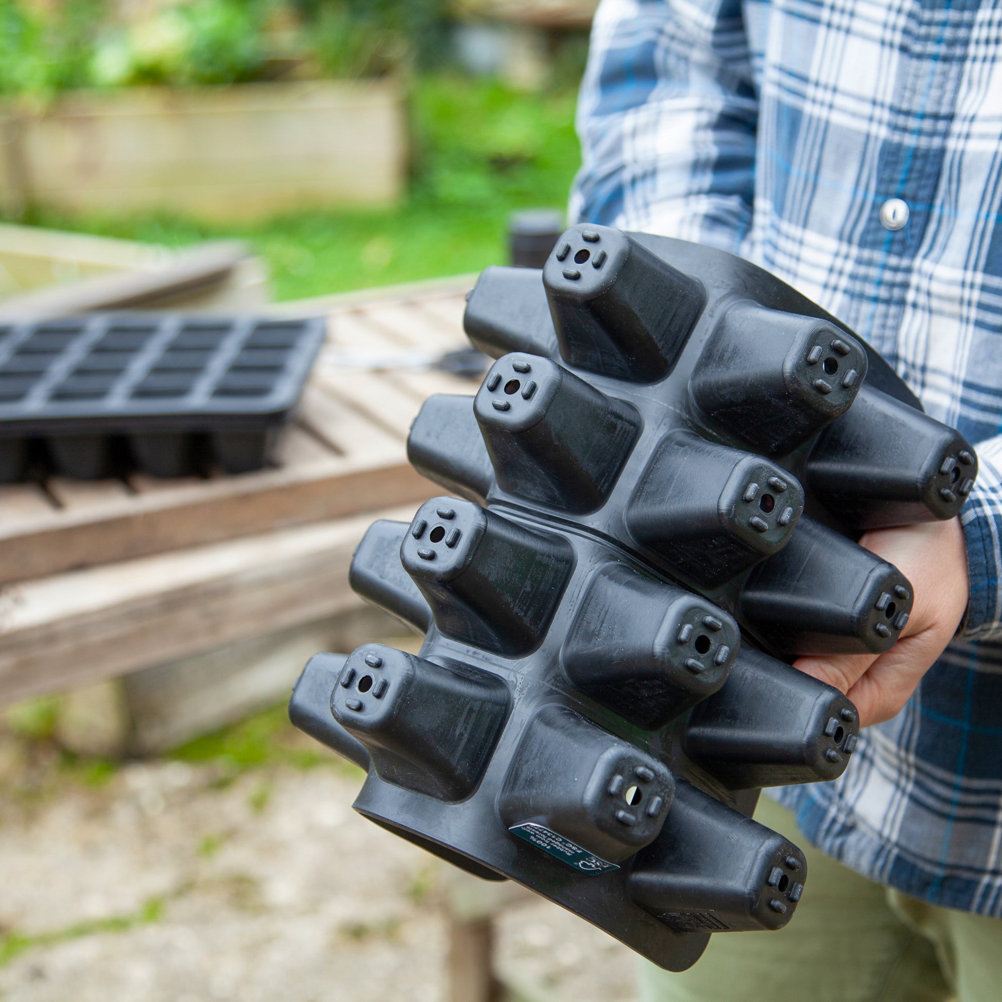 Black, plastic free, twenty cell seed tray made of FSC certified, fair trade natural rubber.