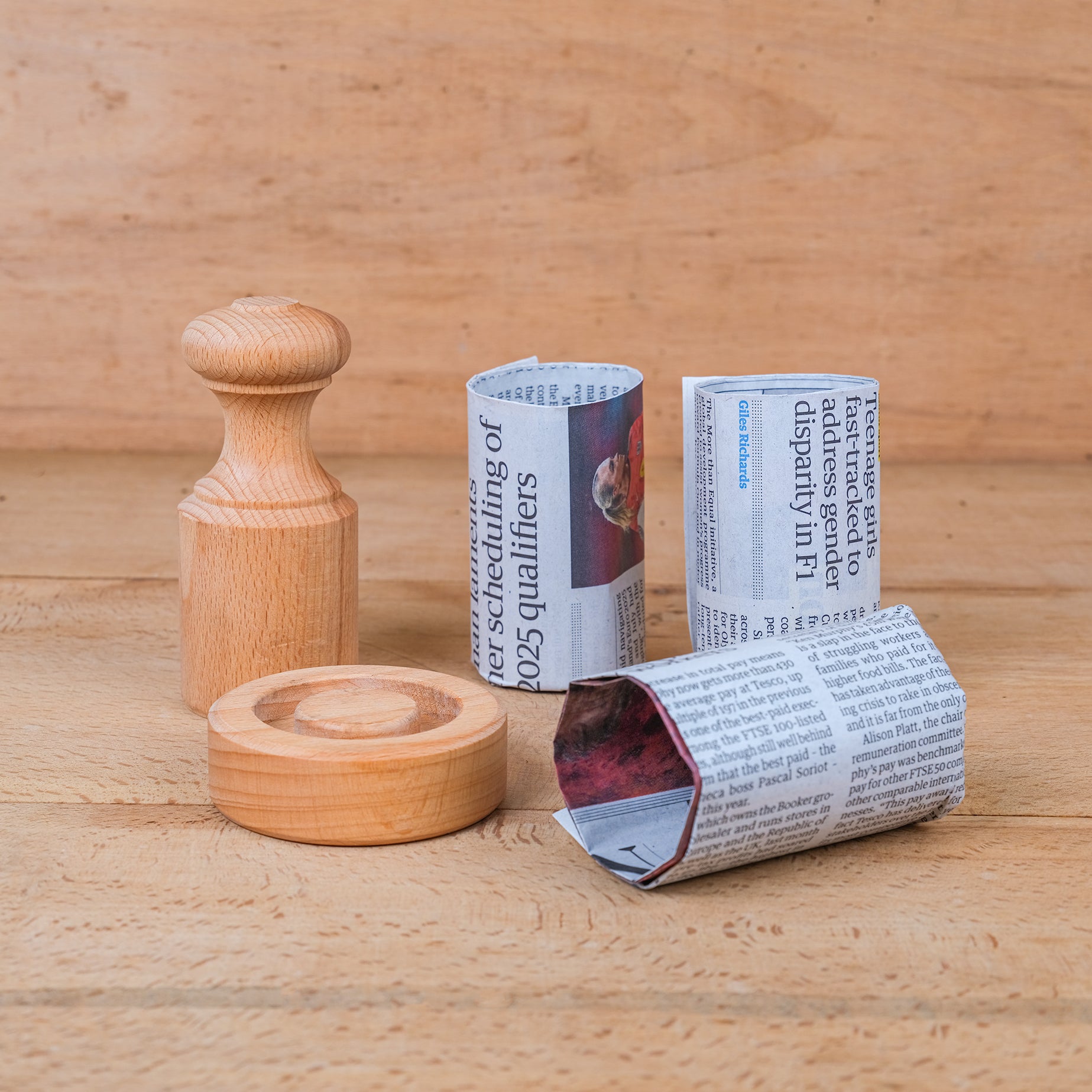 Wooden paper pot maker with plant pots made from old newspaper.