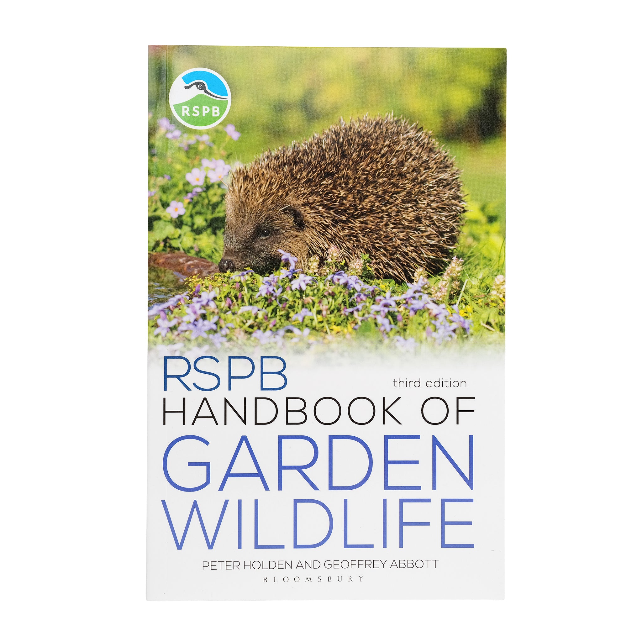 Book cover of RSPB Handbook of Garden Wildlife with a picture of a hedgehog amongst flowers.