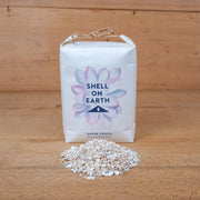 One kilogram mini bag of super crushed shells from Shell on Earth with shells. Used for top dressing plants both indoors and outdoors.