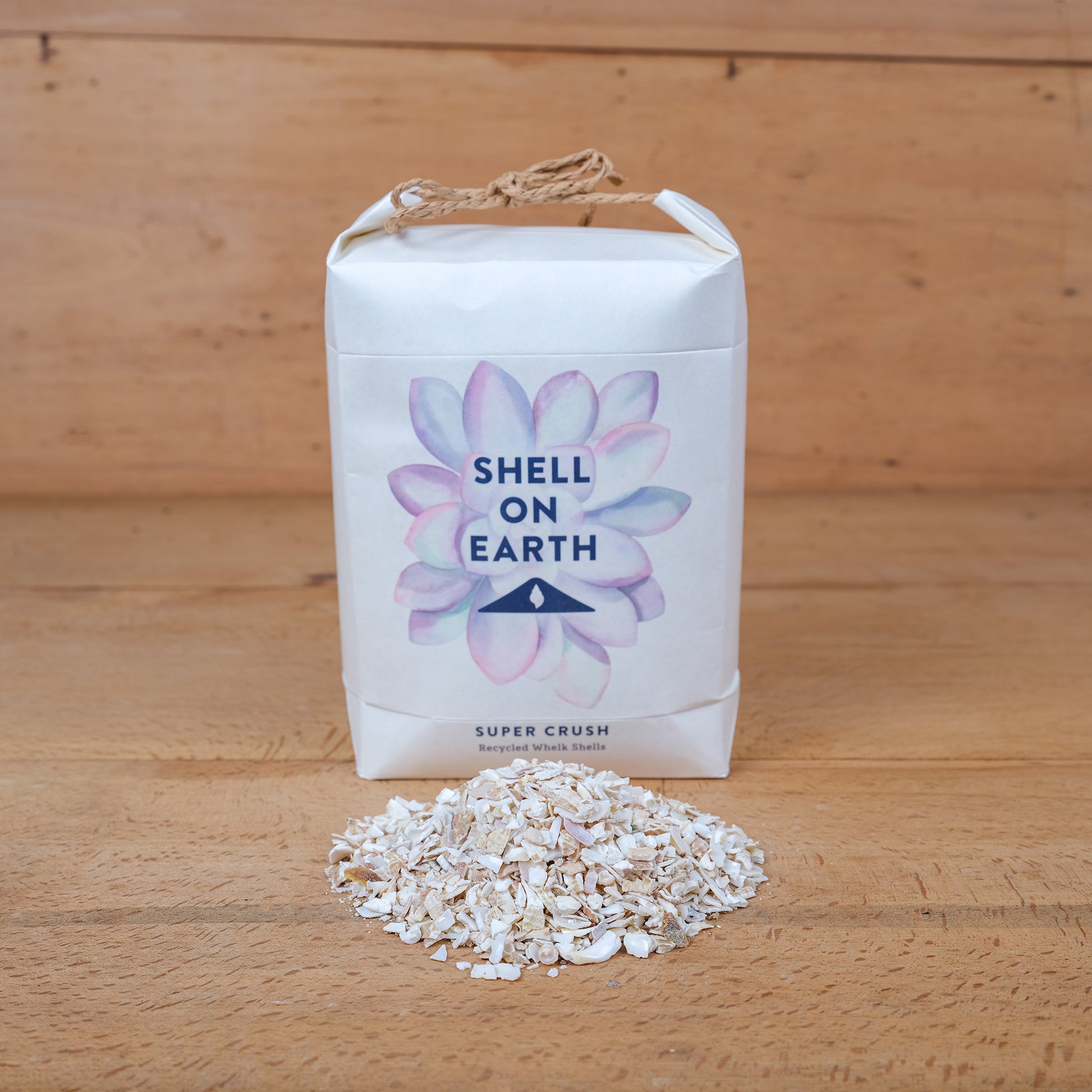 One kilogram mini bag of super crushed shells from Shell on Earth with shells. Used for top dressing plants both indoors and outdoors.