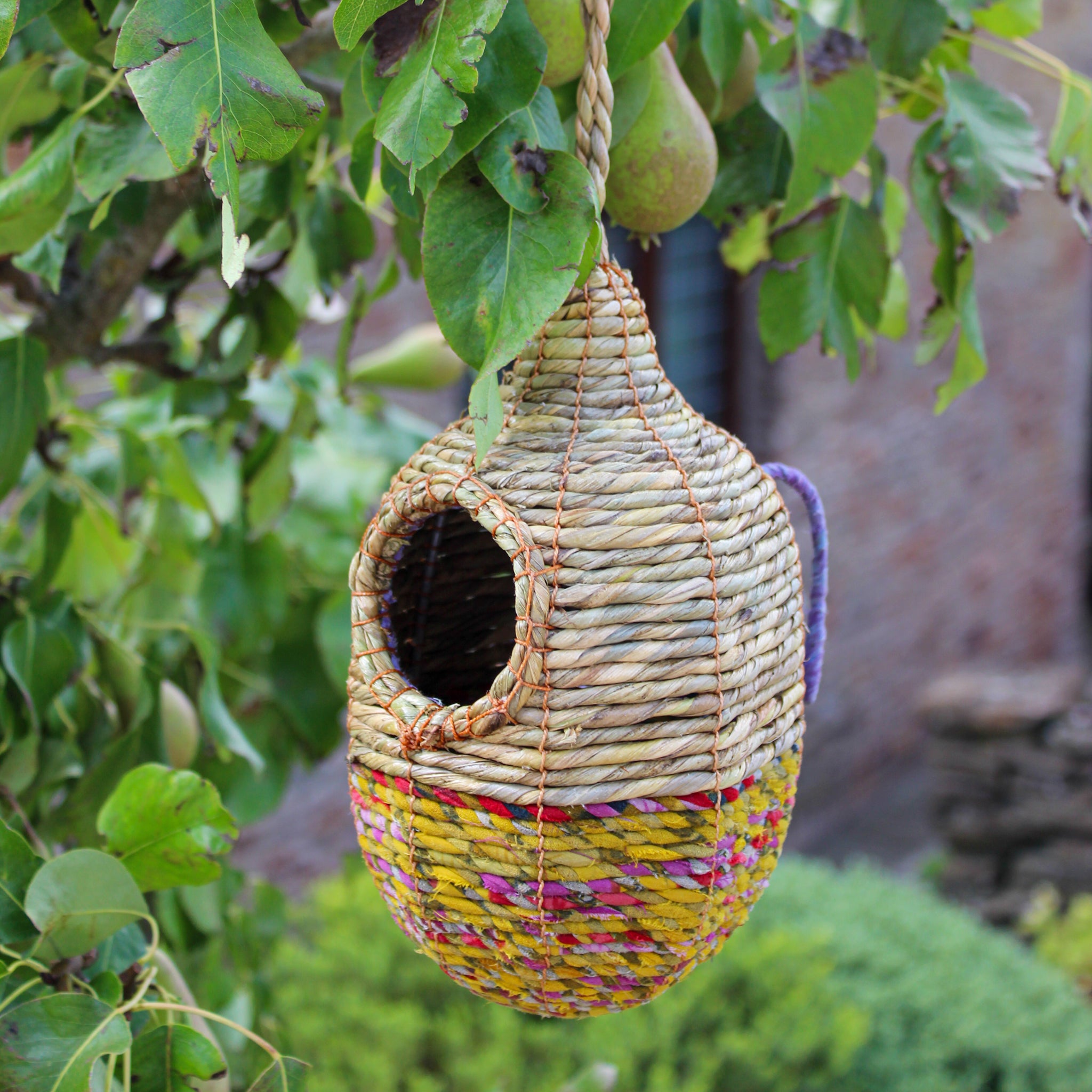 Fair trade, oval, medium sized artisan bird nester made from recycled saris and natural hogla grass.