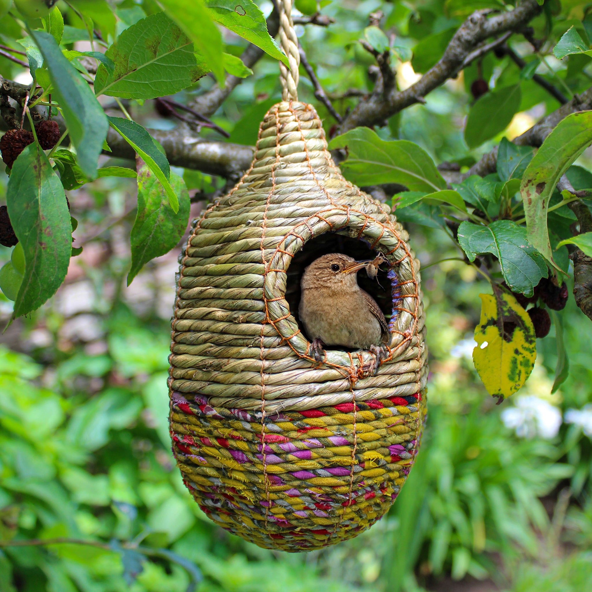 Fair trade, oval, medium sized artisan bird nester made from recycled saris and natural hogla grass.
