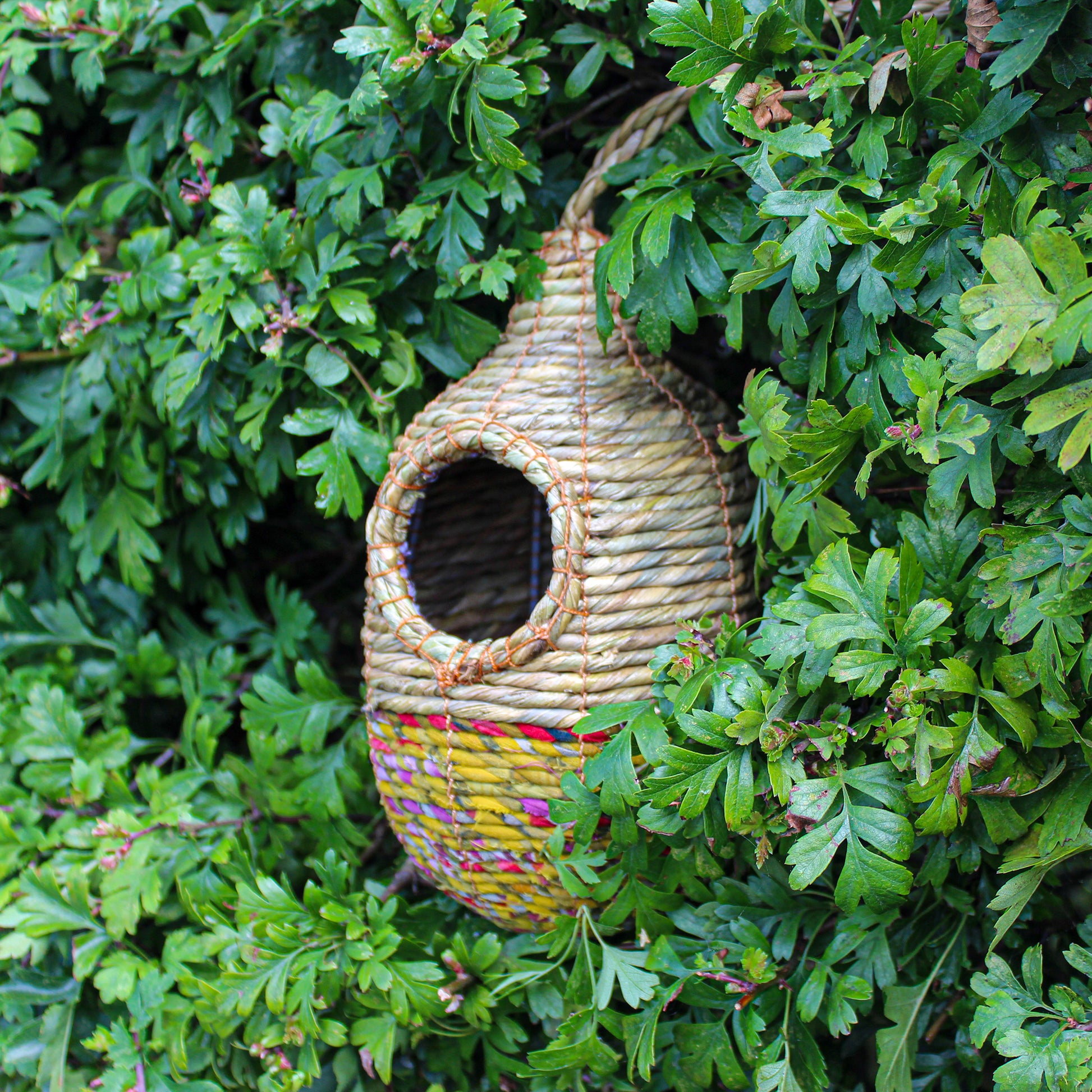 Fair trade, oval, medium sized artisan bird nester made from recycled saris and natural hogla grass.