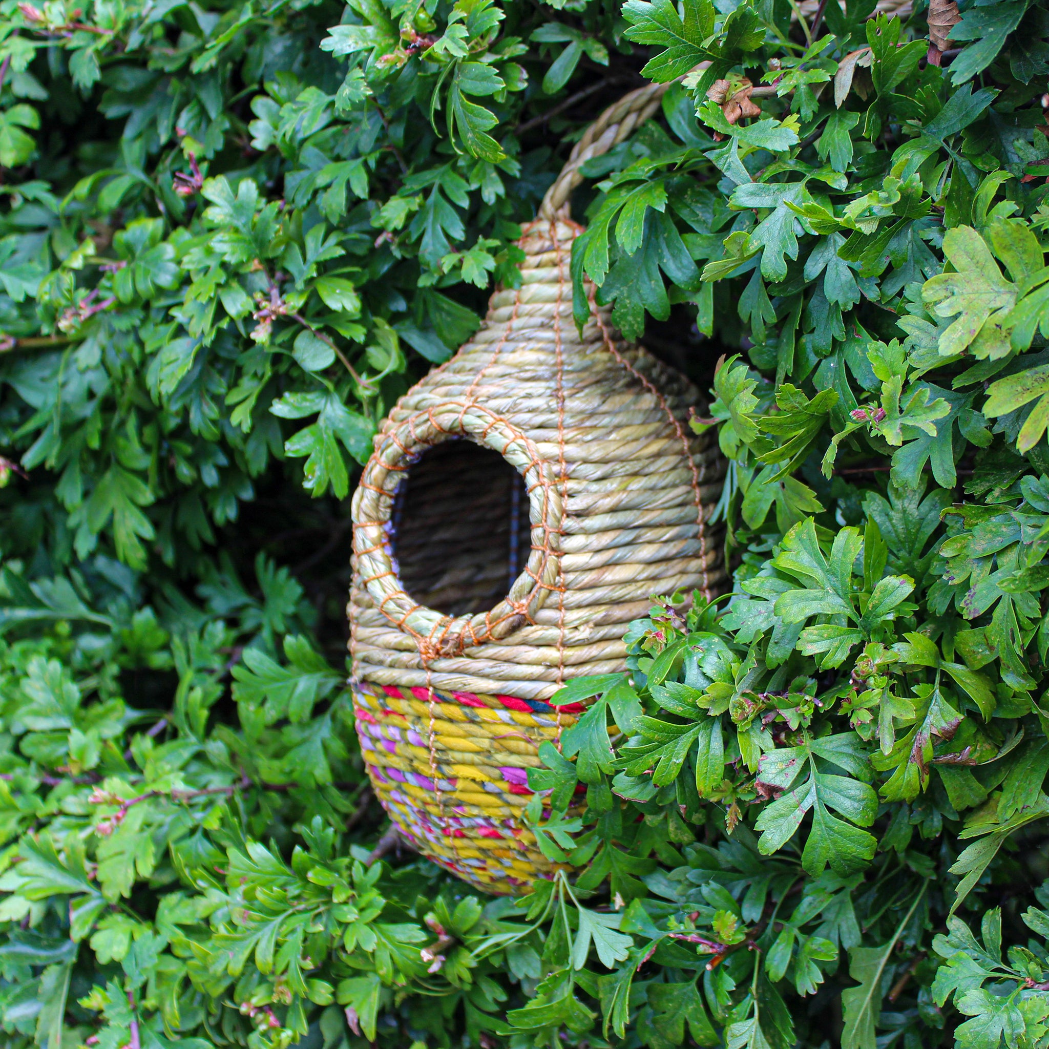 Fair trade, oval, medium sized artisan bird nester made from recycled saris and natural hogla grass.