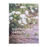 Book cover of 'Sustainable Garden' with white flowers growing along a path.