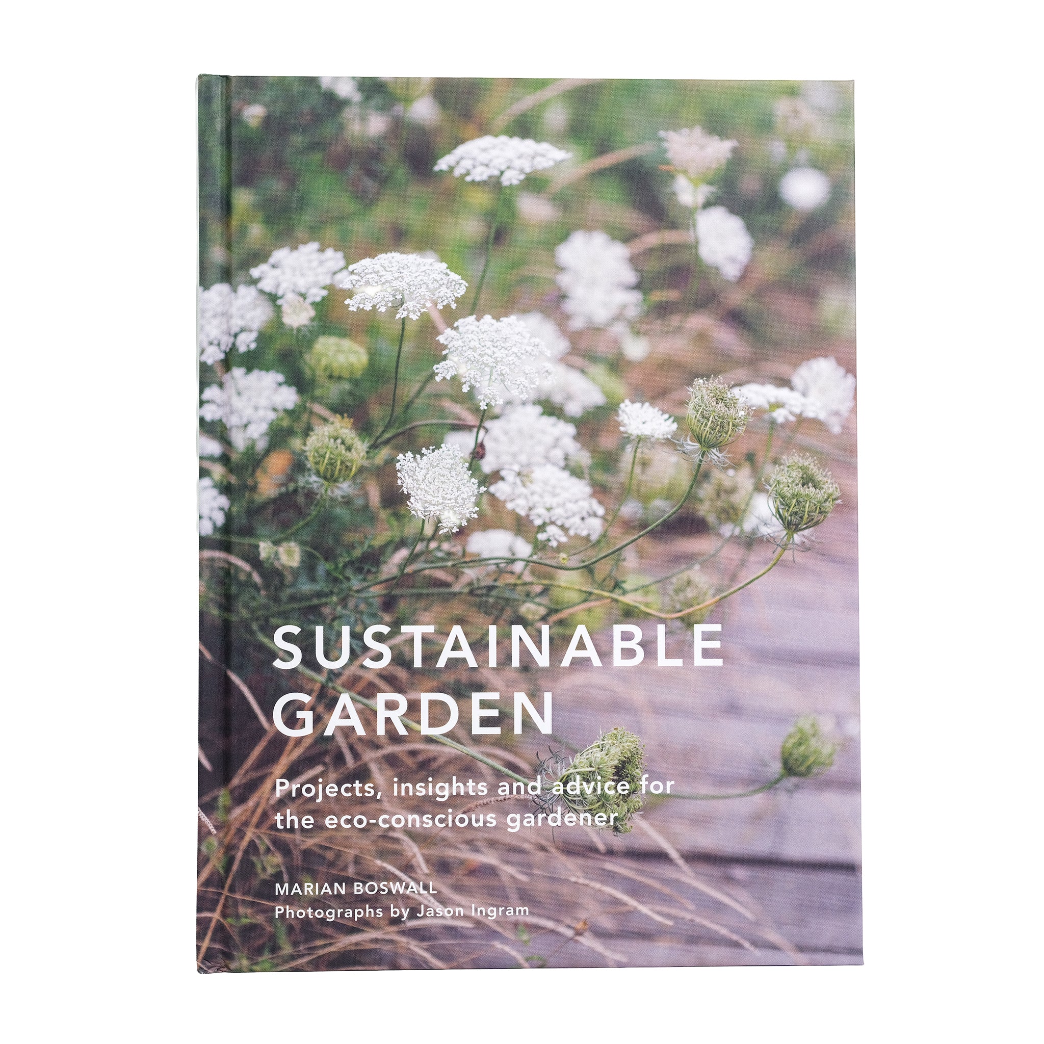 Book cover of 'Sustainable Garden' with white flowers growing along a path.