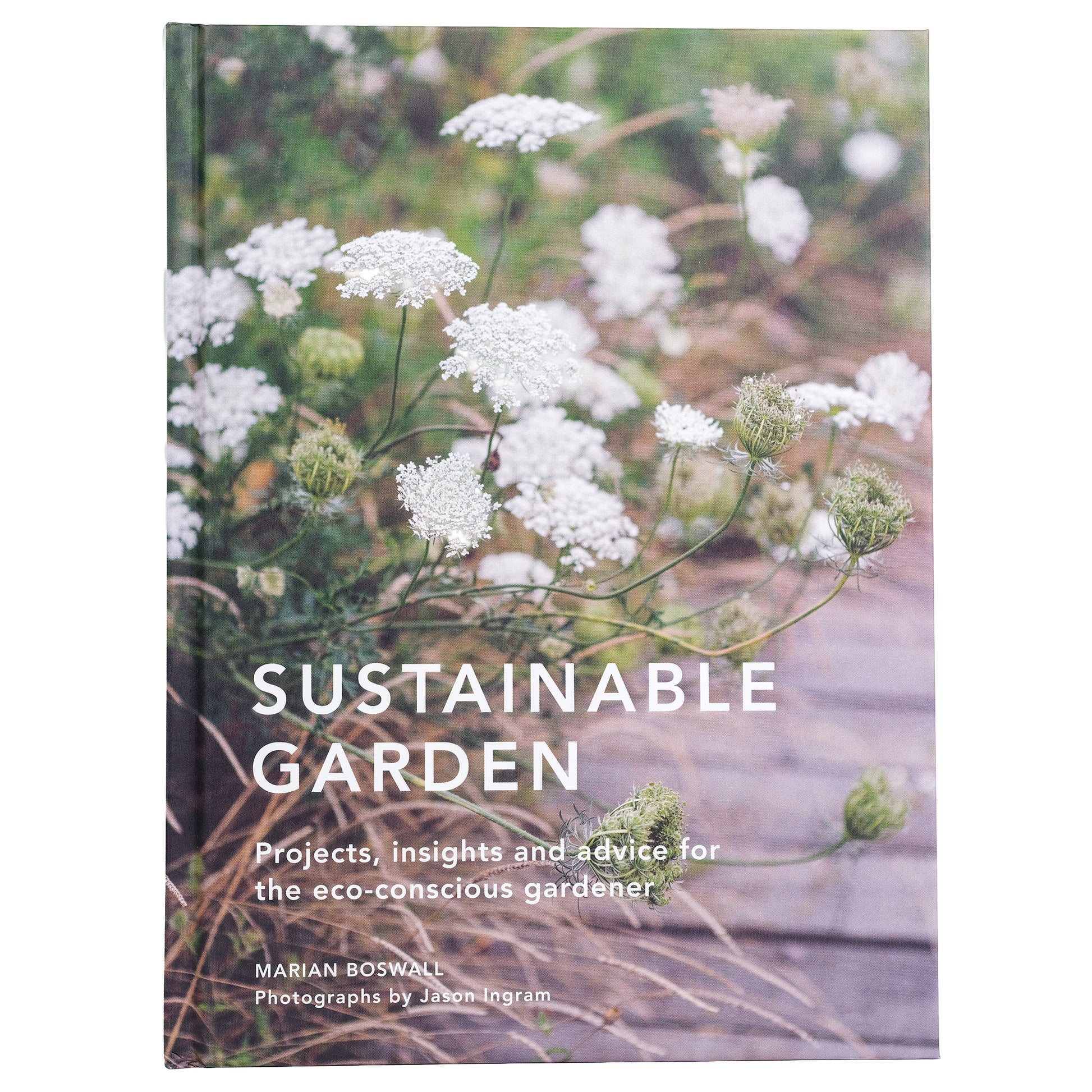 Book cover of 'Sustainable Garden' with white flowers growing along a path.