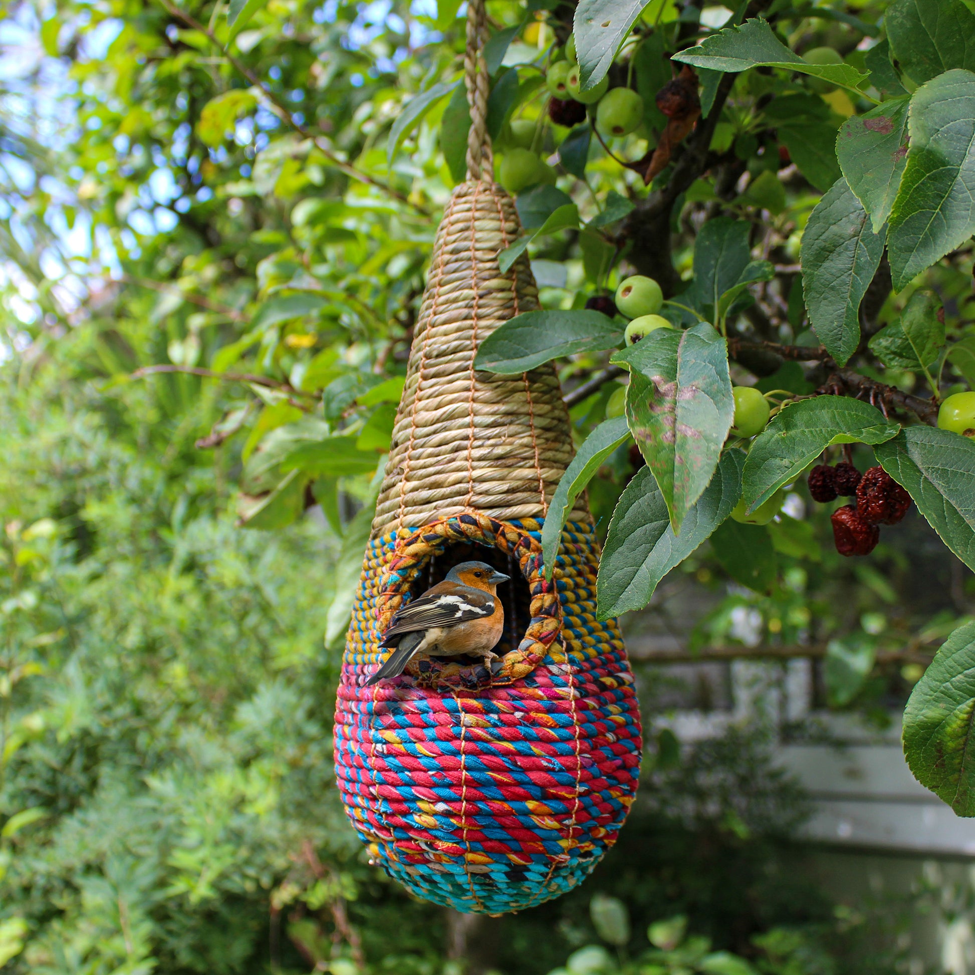 Fair trade, teardrop shaped artisan bird nester made from recycled saris and natural hogla grass.