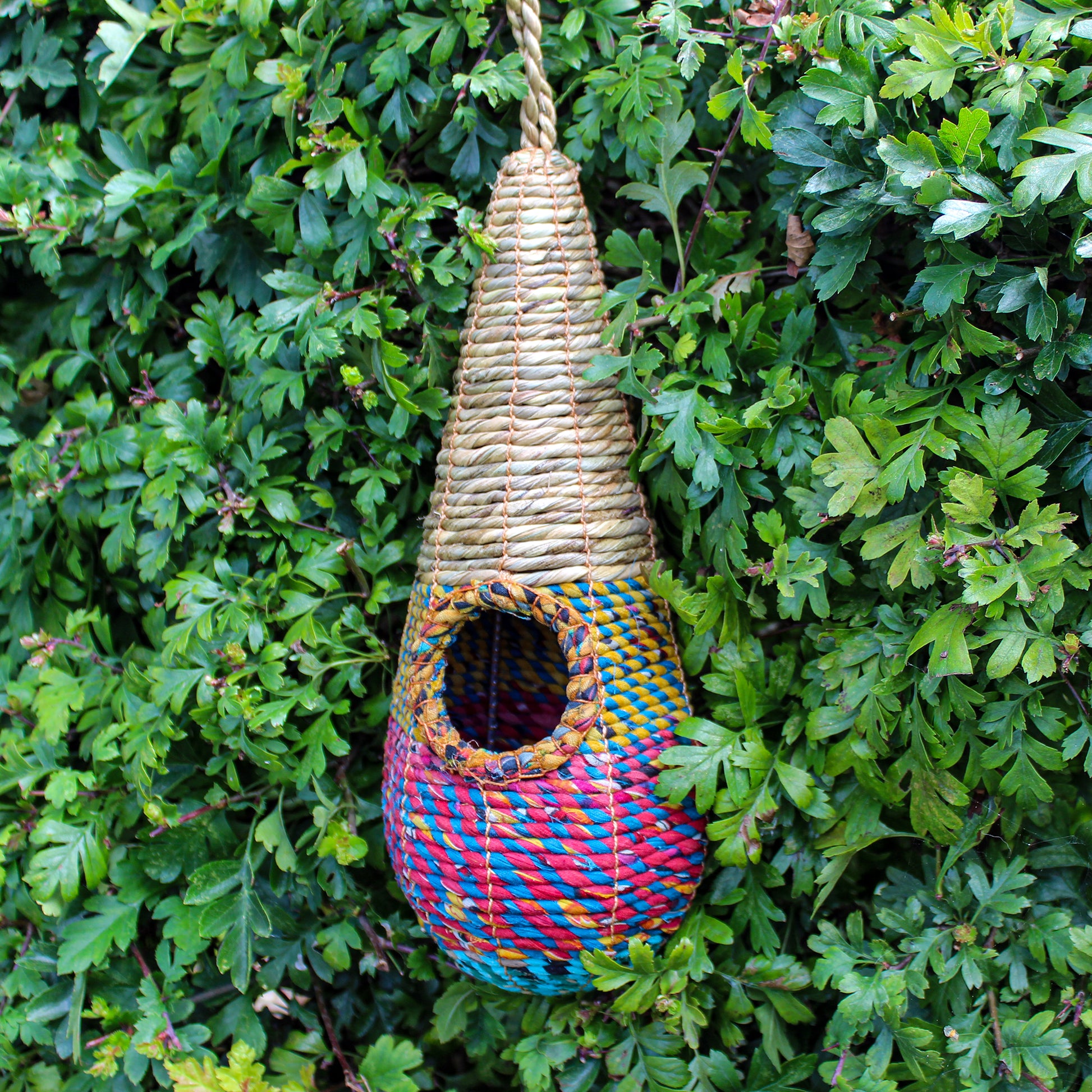 Fair trade, teardrop shaped artisan bird nester made from recycled saris and natural hogla grass.