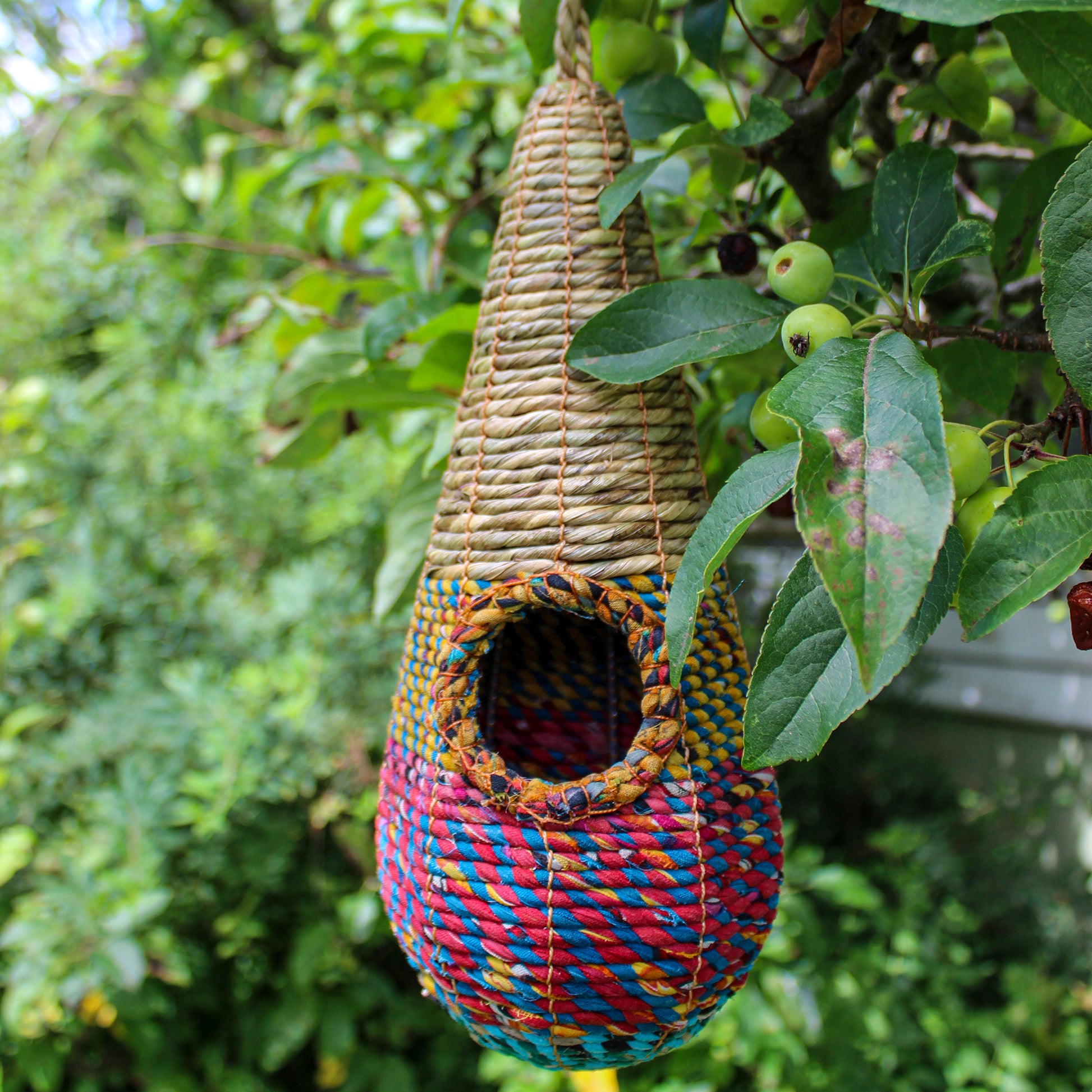 Fair trade, teardrop shaped artisan bird nester made from recycled saris and natural hogla grass.