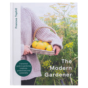 Book cover of 'The Modern Gardener' by Frances Tophill with Frances holding a basket of yellow vegetables.