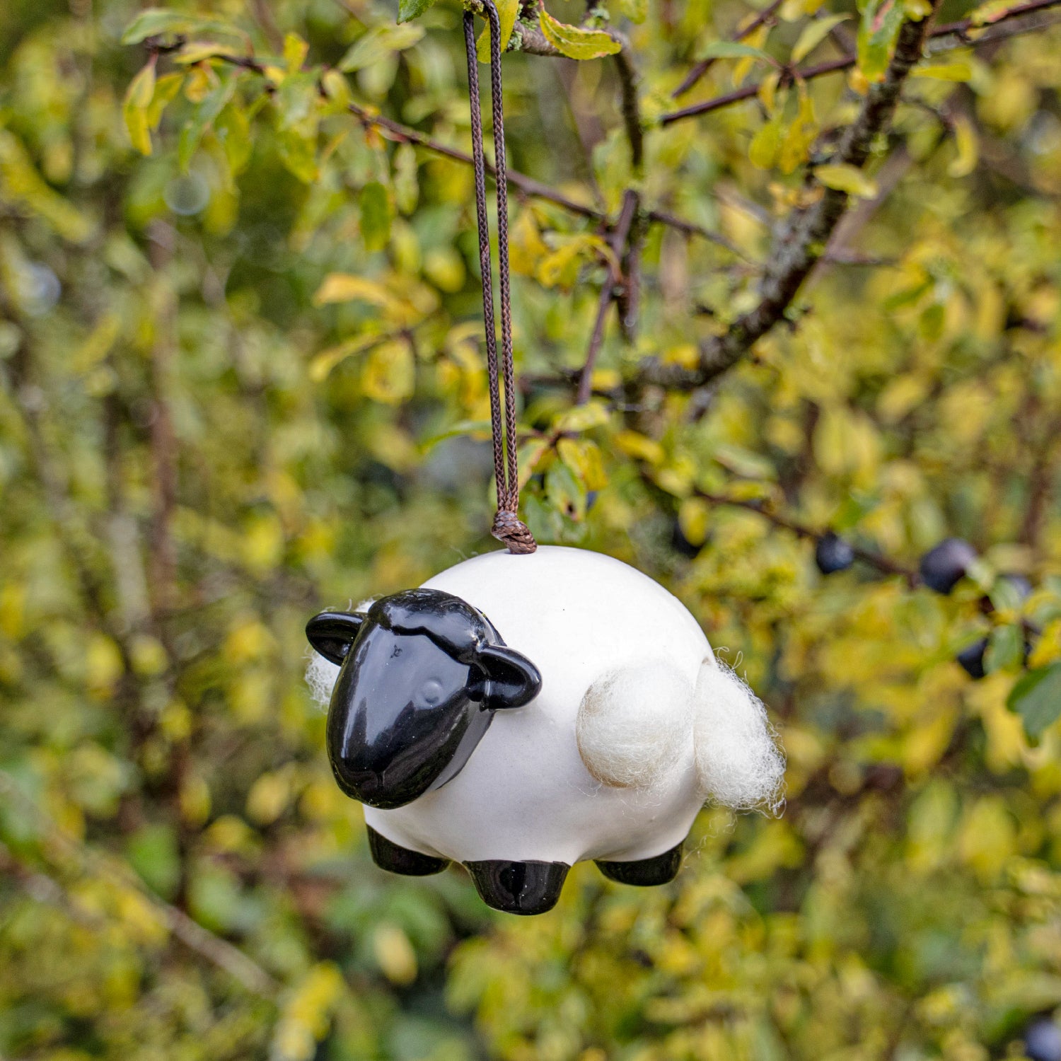 Ceramic ‘Woolie’ the sheep hanging nesting wool dispenser for birds.