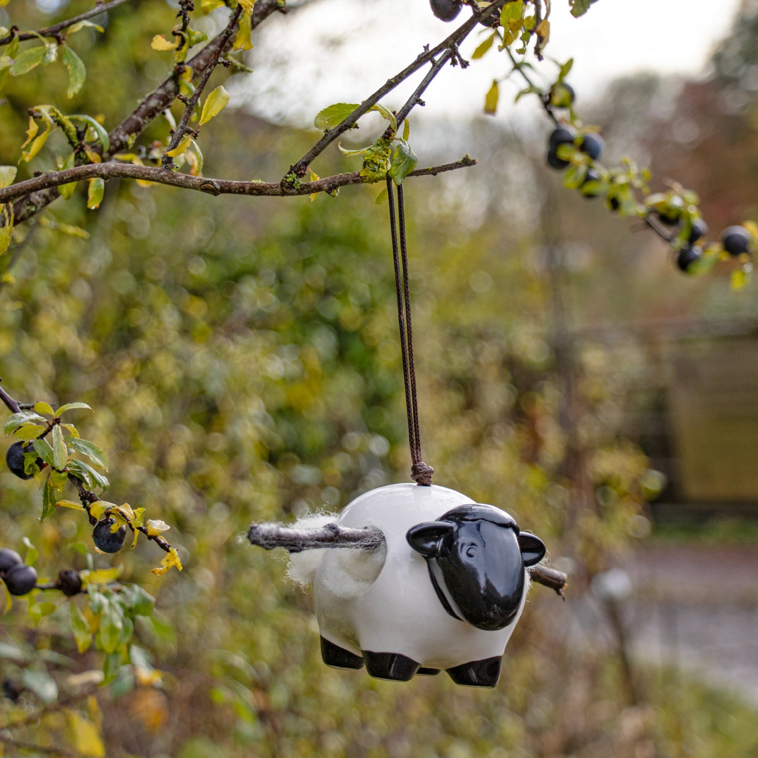 Ceramic ‘Woolie’ the sheep hanging nesting wool dispenser for birds.