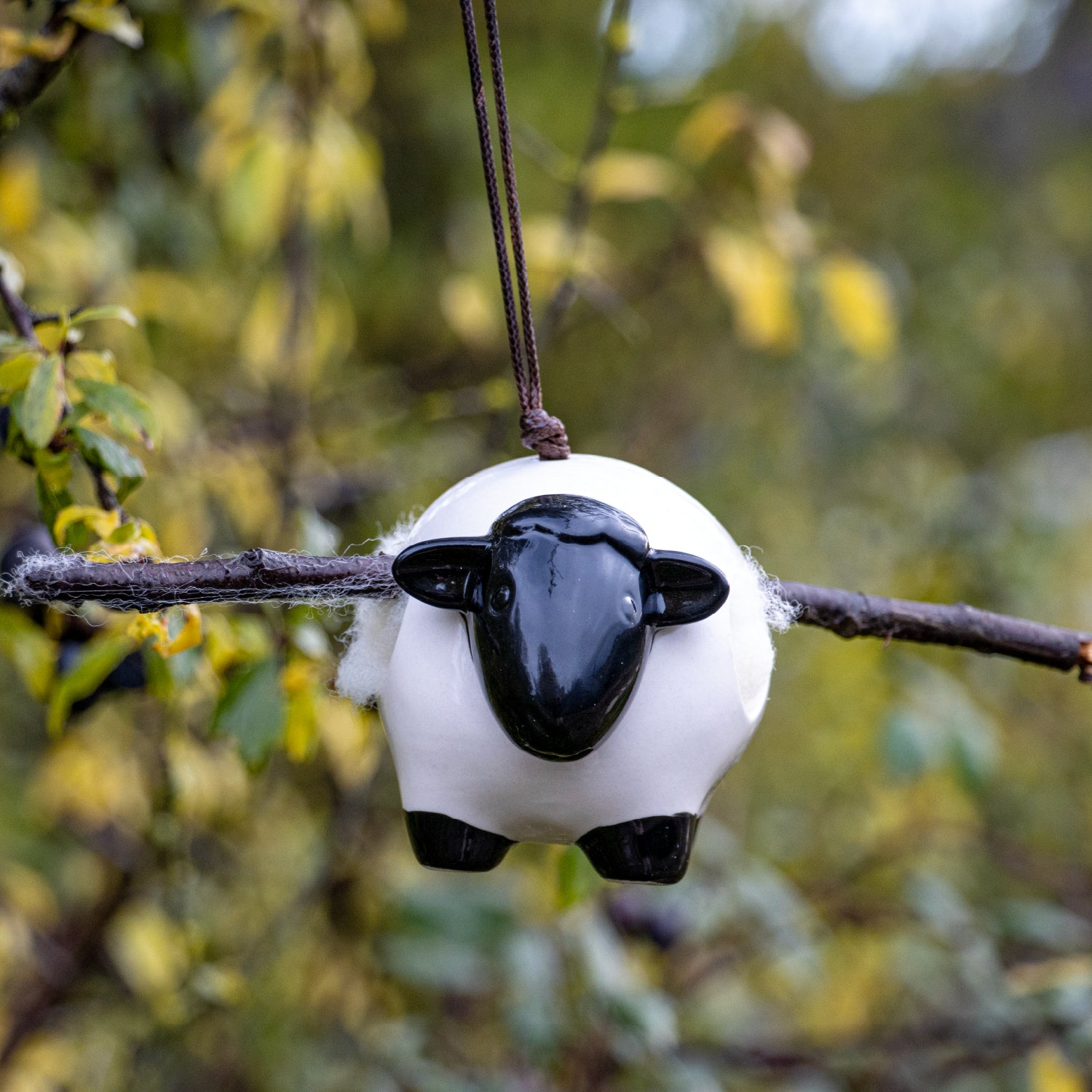 Ceramic ‘Woolie’ the sheep hanging nesting wool dispenser for birds.